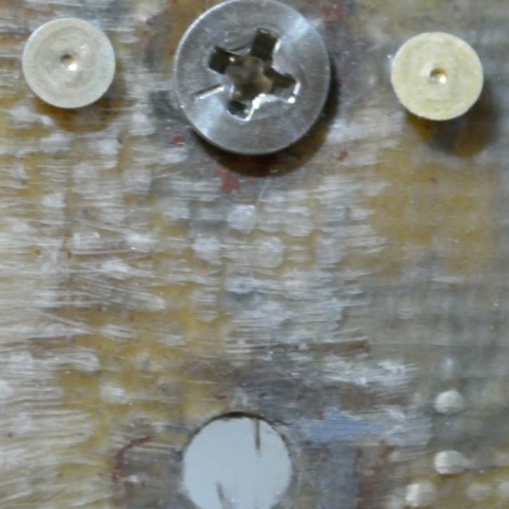 Countersunk SS screw used to center the nutplate in the hole.